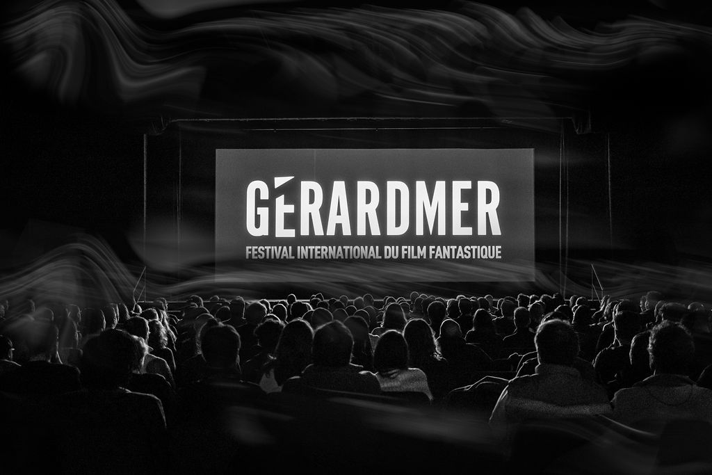 Audience watching Gérardmer International Fantastic Film Festival screening in dark theater