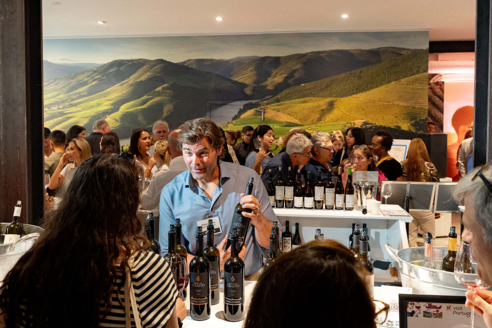 Man presenting wines from portugal in front of small crowd