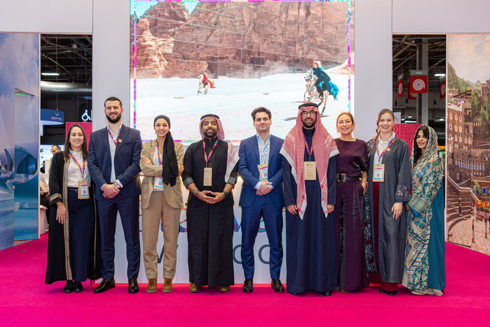 group picture in front of tourism stand