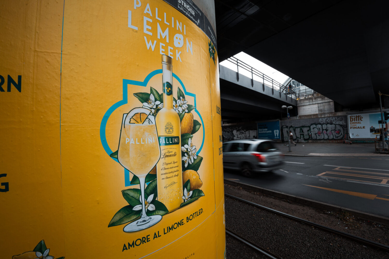 Pallini poster advertising under a bridge
