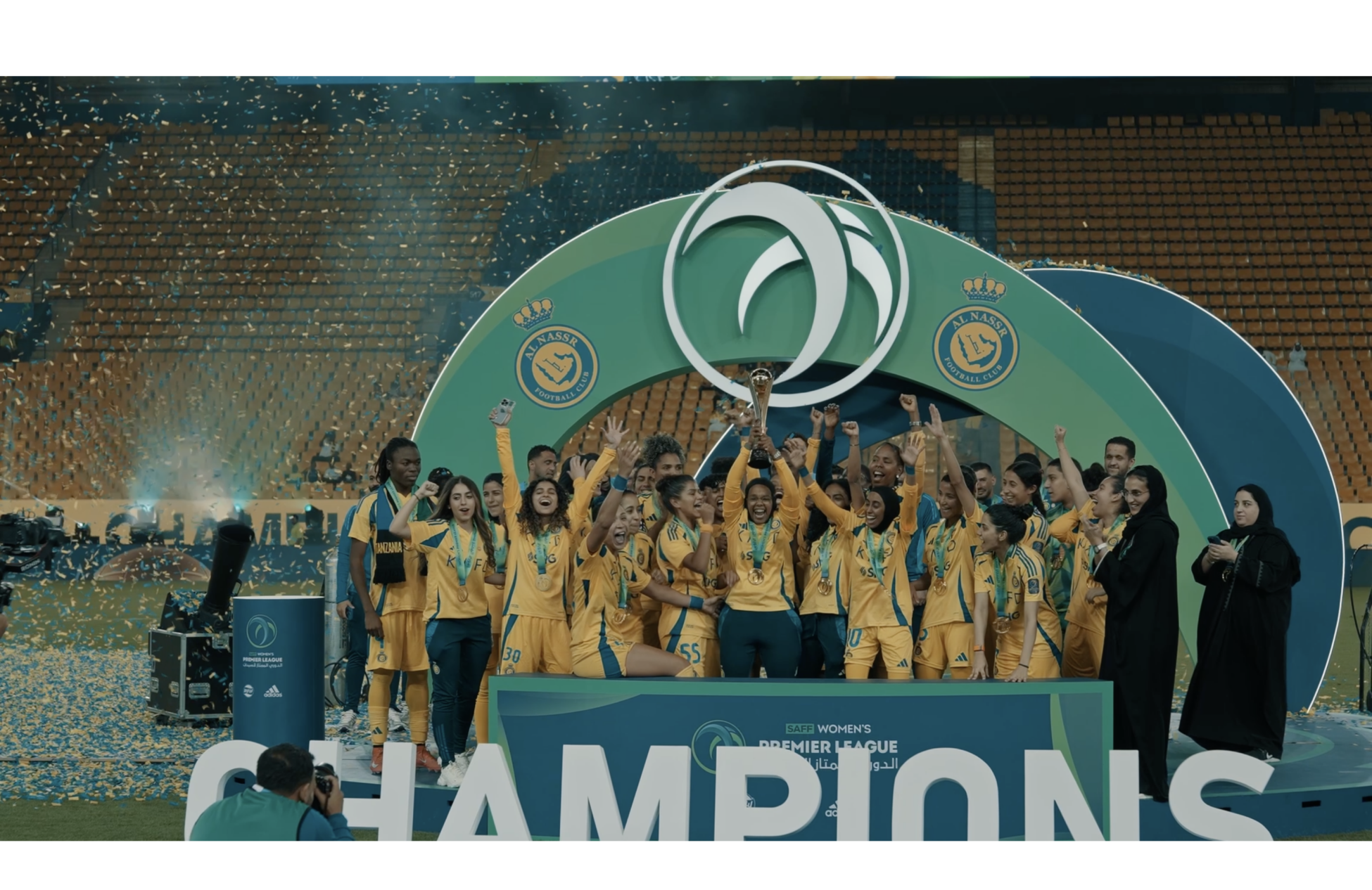 Women football team celebrating by the podium
